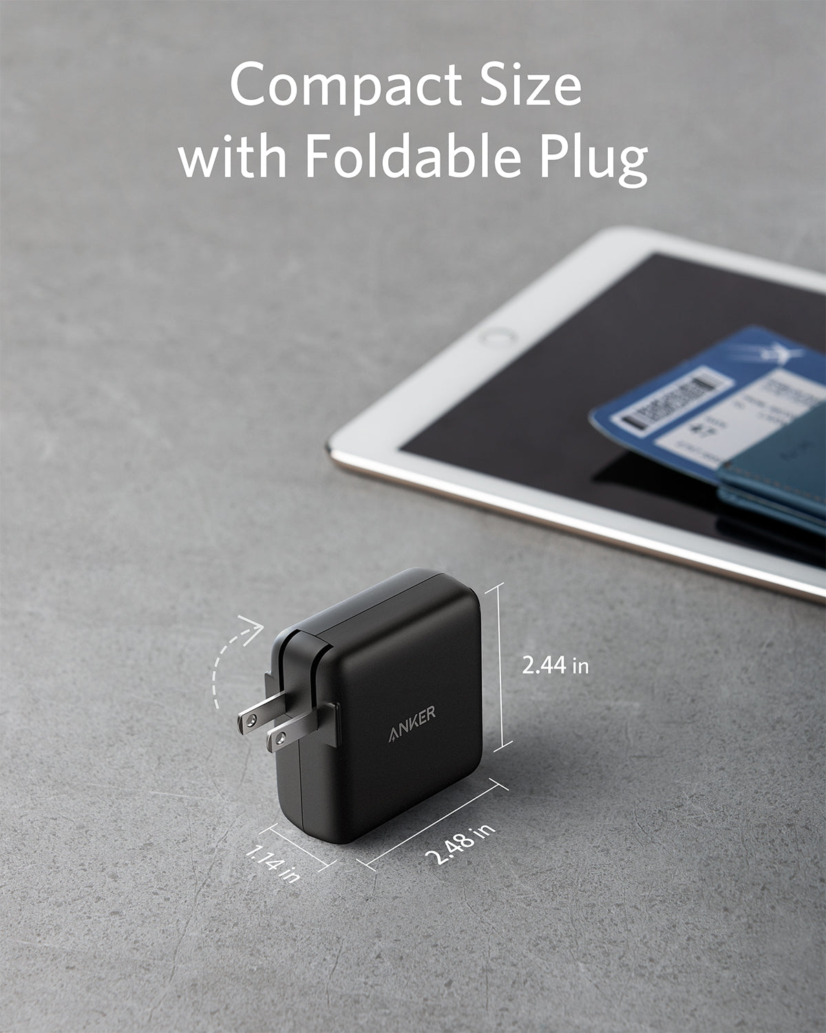 A black Anker 324 Charger (40W) with a foldable plug rests on a gray surface, showing its compact 2.44 x 2.13 x 1.14 in size. Nearby are a white tablet, blue passport, and boarding pass. Text above highlights fast charging capabilities.