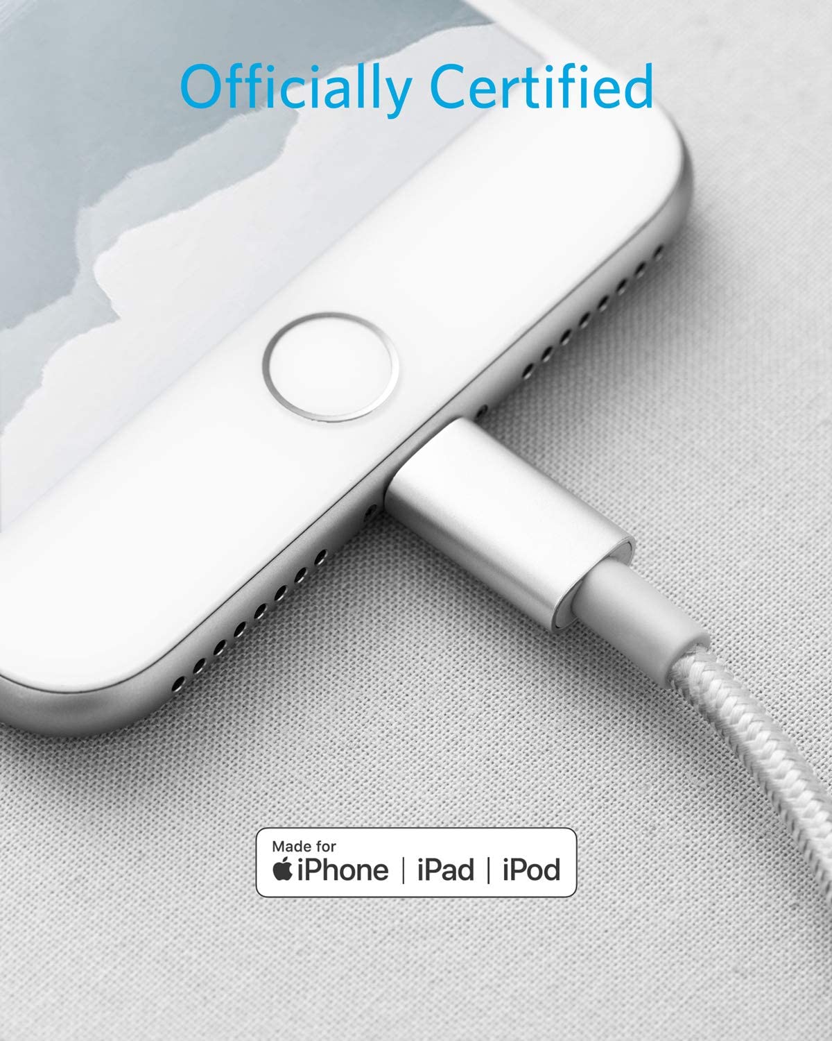Close-up of a silver iPhone with an Anker 331 USB-C to Lightning Cable (MFi Certified) plugged into its Lightning port, resting on light gray fabric. Blue “Officially Certified” text is above, with Apple certification icons below. Brand: Anker.