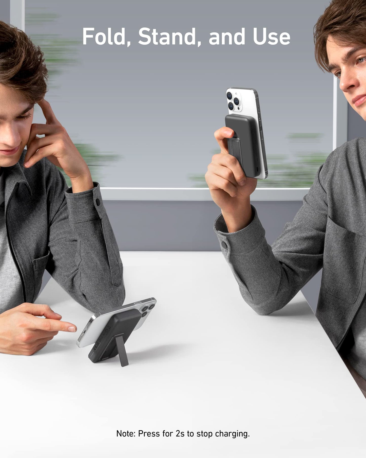 Two young men in gray shirts use Anker 633 Magnetic Battery stands by Anker at a white table—one interacting with his phone laid flat, the other holding his phone upright. Above them appears the phrase “Fold, Stand, and Use.”.