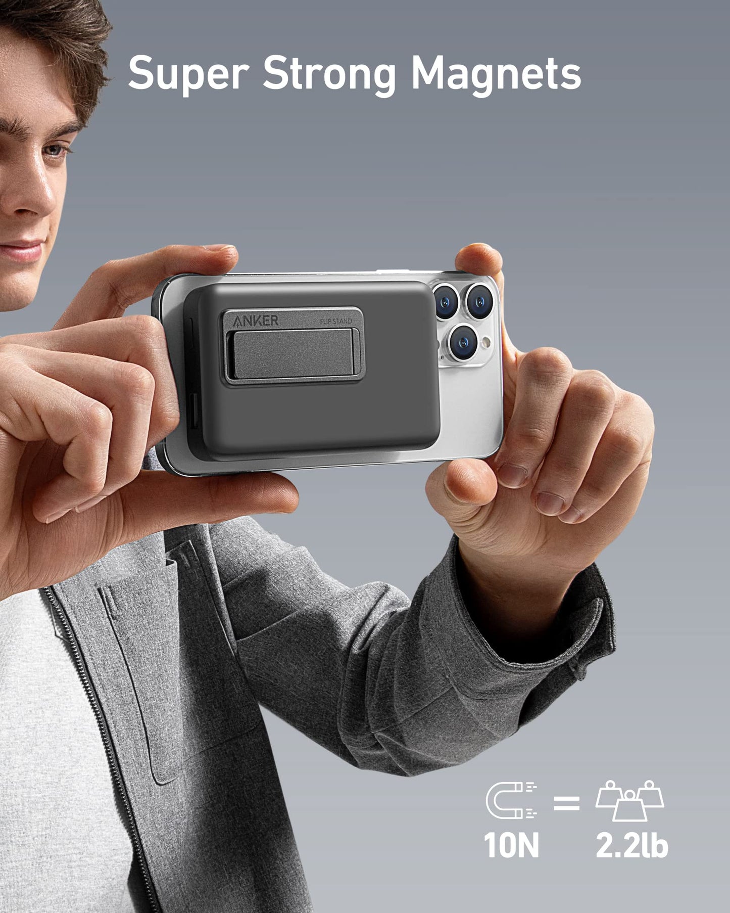A hand holds an Anker 633 Magnetic Battery wallet attached to a smartphone, secured by super strong magnets (10N/2.2lb strength). Text reads “Super Strong Magnets.” The light gray background highlights this 10,000mAh Anker accessory.