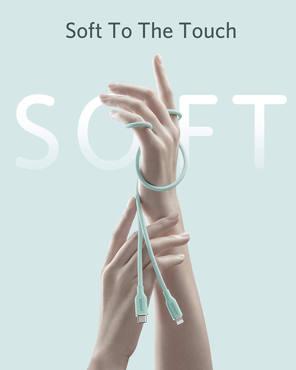 A light blue Anker 641 USB-C to Lightning Cable (Flow, 3 ft Silicone) is gently wrapped around two raised hands against a pale blue background. Large white letters spell SOFT, with "Soft To The Touch" written above.