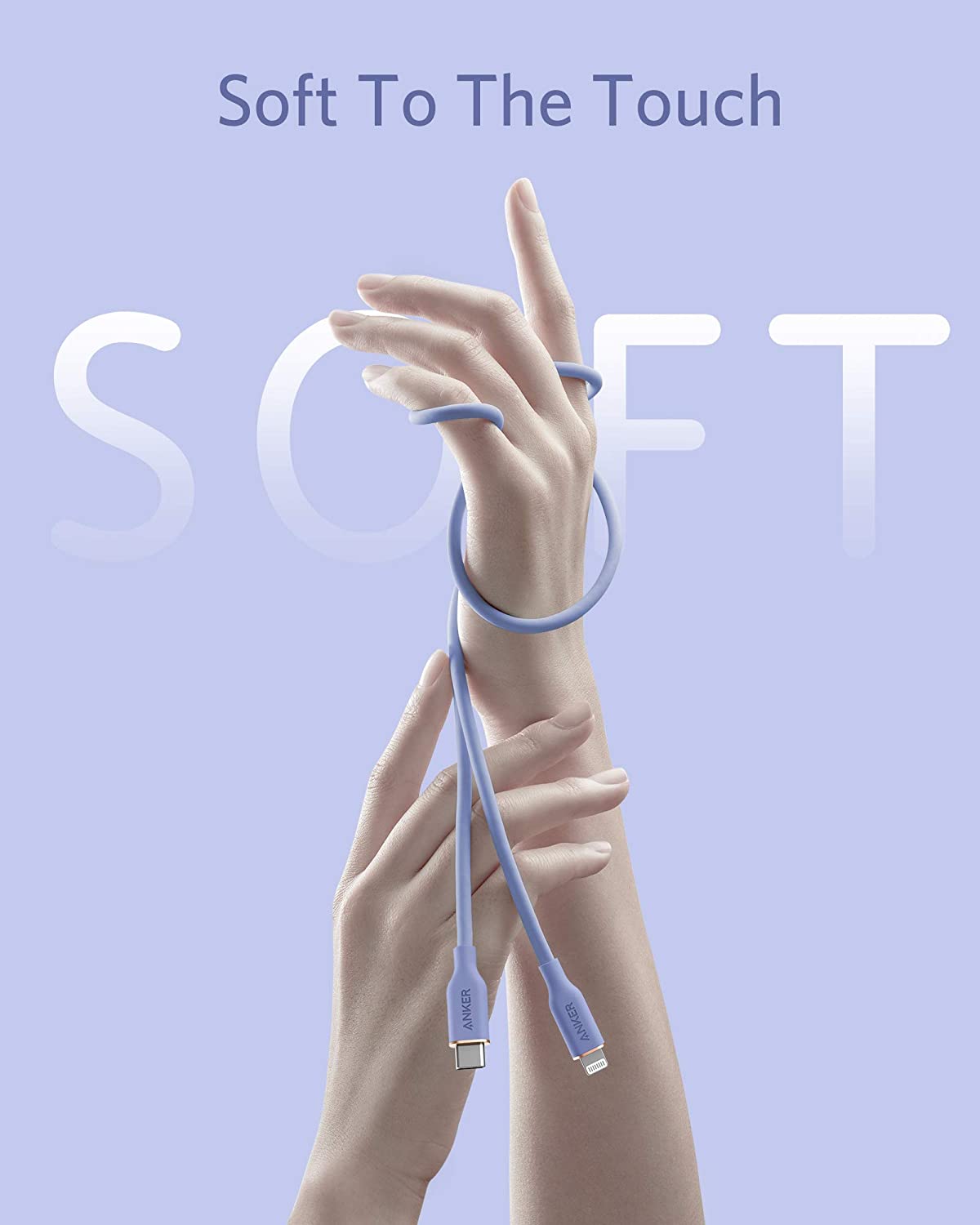 Two hands appear against a light lavender background, gently holding and wrapping the Anker 641 USB-C to Lightning Cable (Flow, 3 ft Silicone)—a soft blue silicone charging cable—while translucent SOFT lettering is visible in the background above “Soft To The Touch.”.