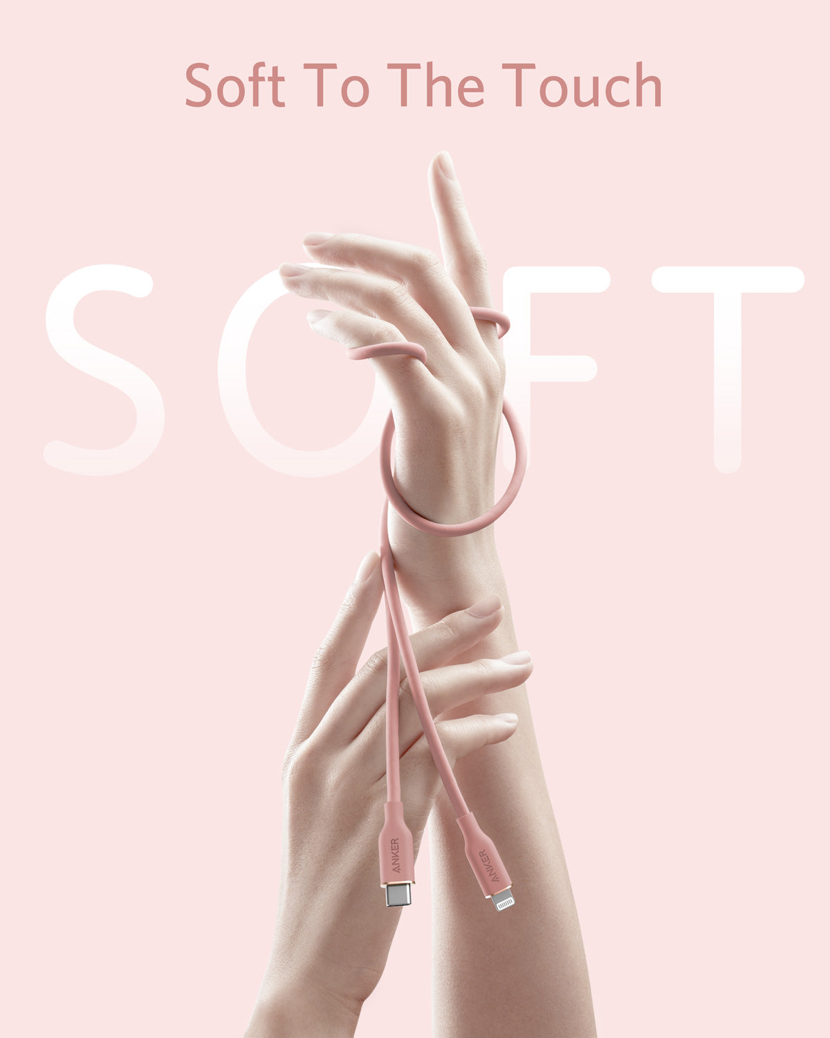 Two hands intertwine with the Anker 641 USB-C to Lightning Cable (Flow, 3 ft Silicone) in pink against a pale background. Large, faded "SOFT" text and "Soft To The Touch" highlight its gentle, flexible silicone by Anker.