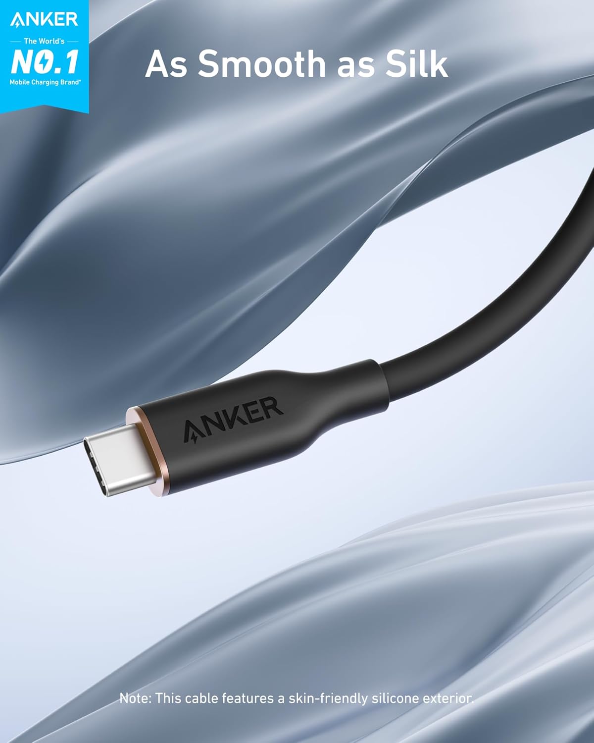 A close-up of the Anker 643 USB-C to USB-C Cable (Flow, Silicone) with black and silver connectors is set against a silky background. Text reads: As Smooth as Silk. From Anker, the World's No.1 Mobile Charging Brand, with a skin-friendly silicone exterior.