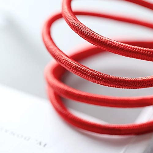 Close-up of three bright red elastic hair bands stacked in a spiral on a white surface, arranged with the minimal precision you’d expect from an Anker Powerline+ USB C to USB 3.0 Cable by Anker. The texture of the bands is clearly visible.