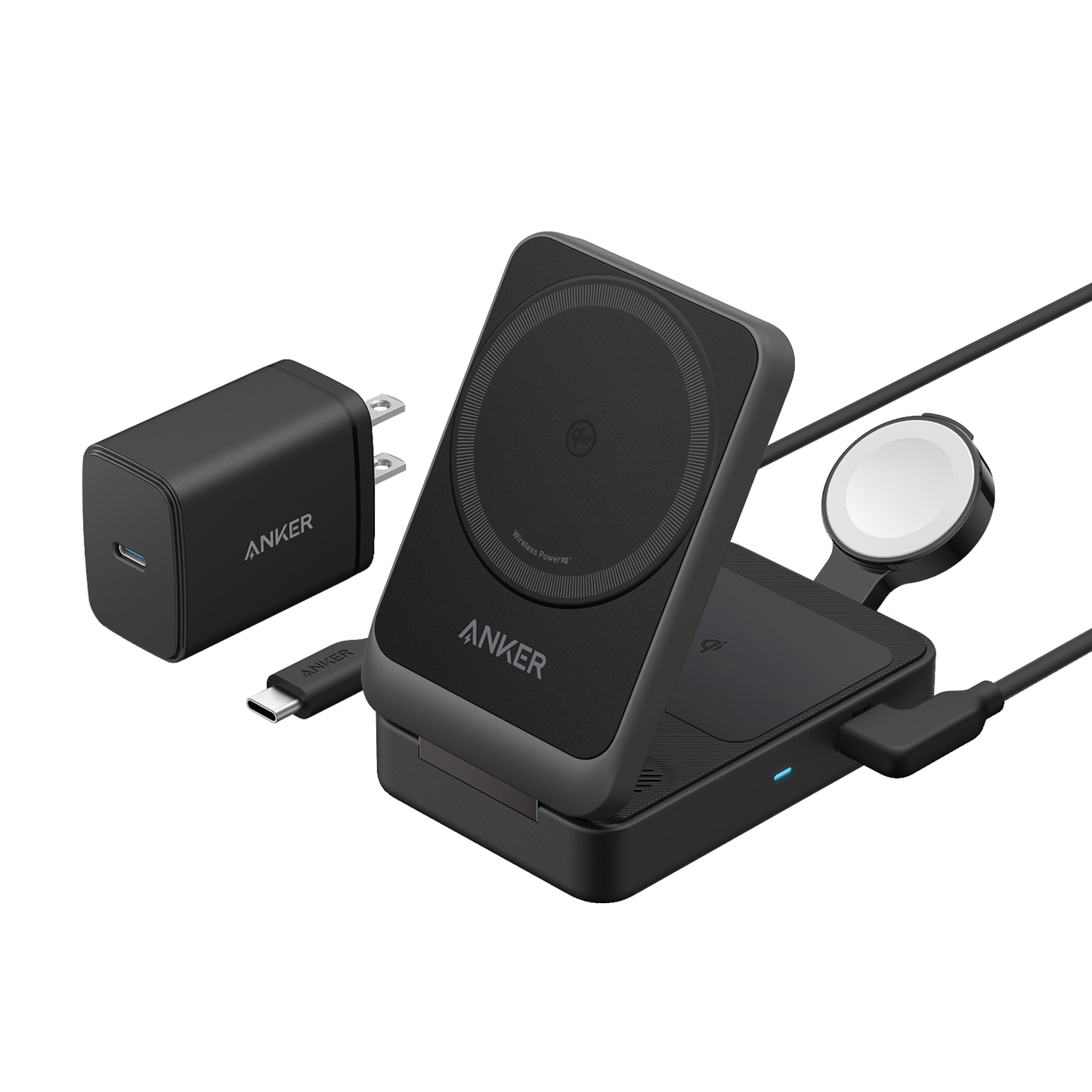 The Anker MagGo Wireless Charging Station (Foldable 3-in-1) by Anker is shown in black with a phone on its MagSafe-compatible magnetic stand, an Apple Watch charging dock, a USB-C wall plug adapter, and USB-C cable on a white background.