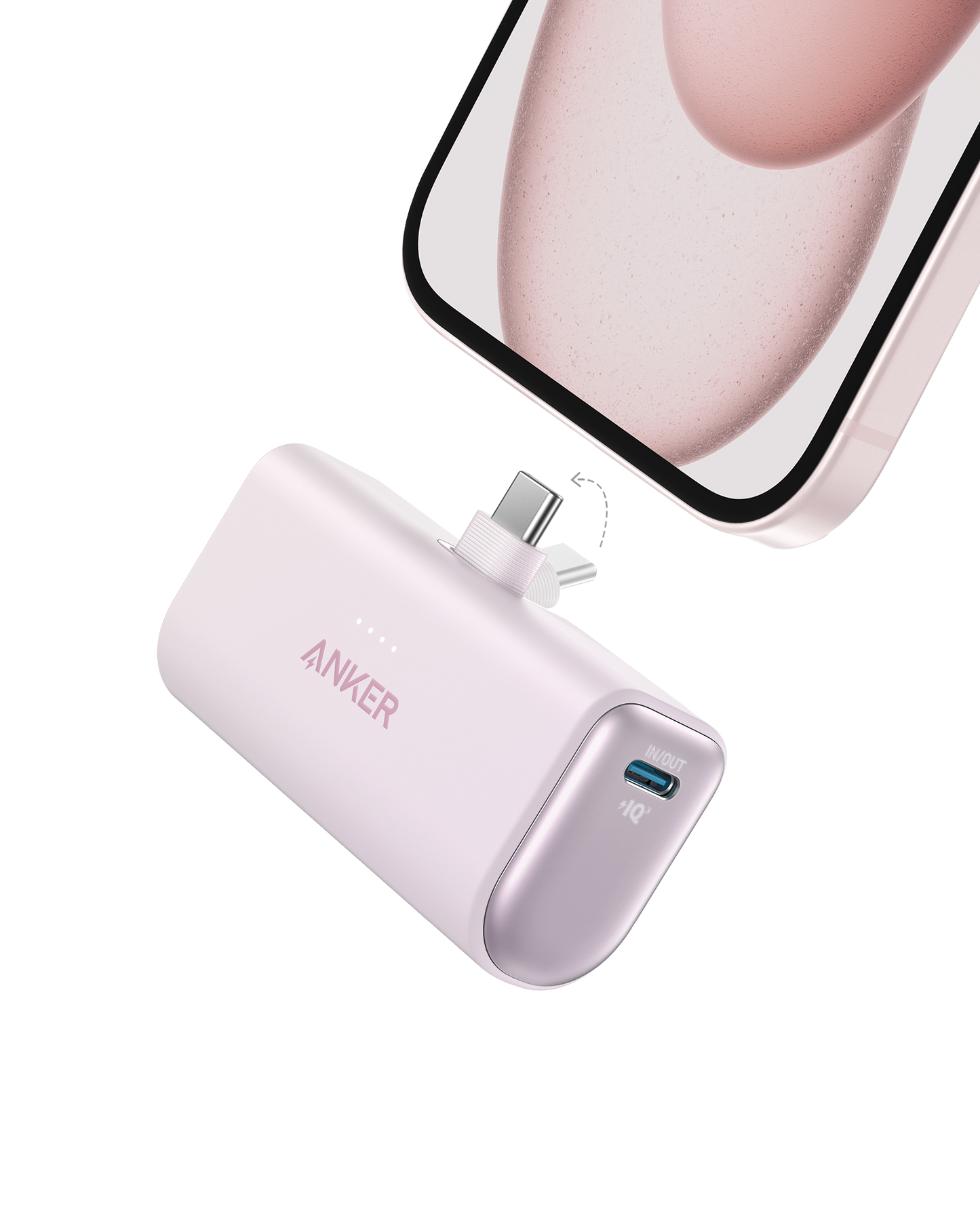 The Anker Nano Power Bank (22.5W, Built-In USB-C Connector) in lavender by Anker is shown about to plug into a smartphone, featuring LED indicator lights and a side USB-C input port against a plain white background.