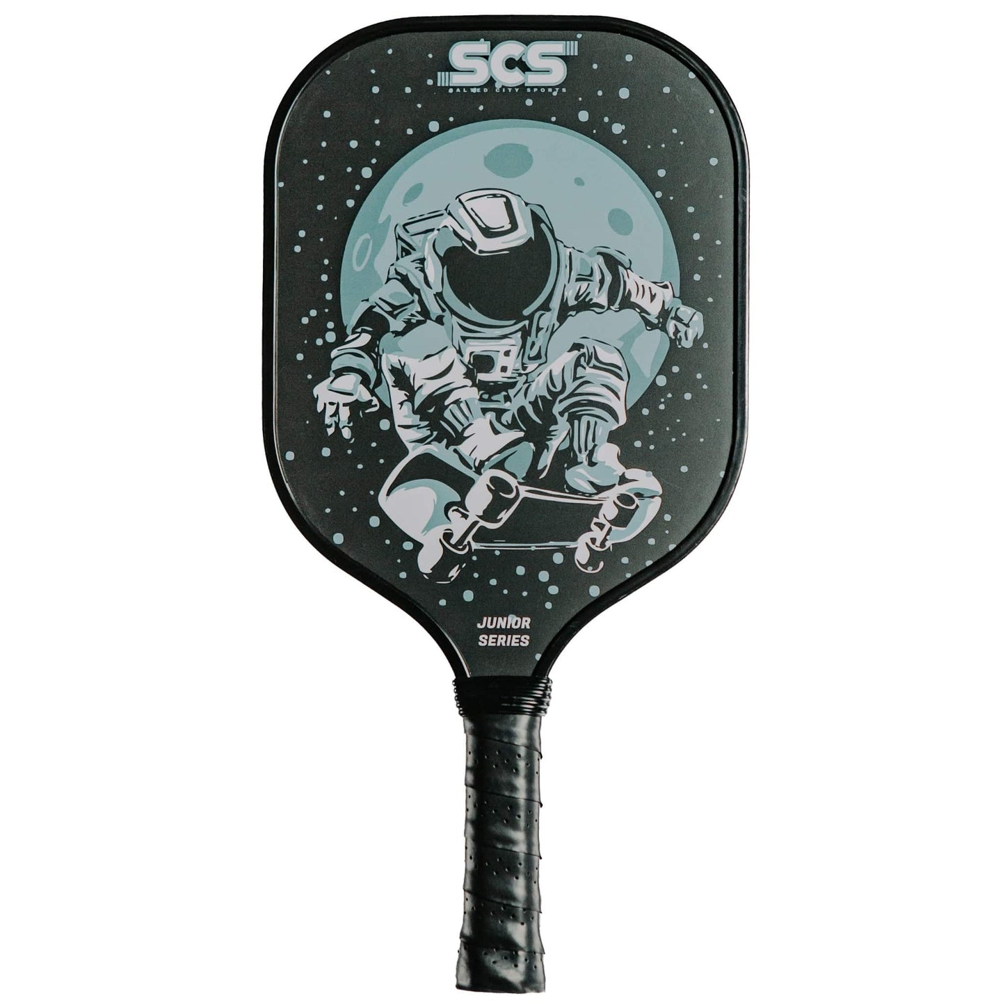 The Astro Junior Series Kids Pickleball Paddle by Salted City Sports features a black design with an astronaut skateboarding before a blue moon, SCS branding on top, JUNIOR SERIES by the handle, and a comfy black grip-taped handle.