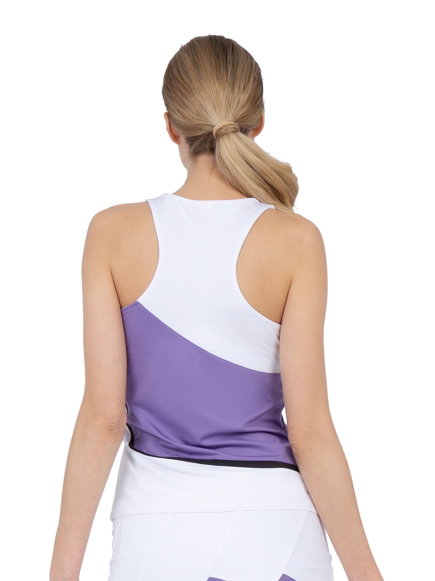 A woman with blonde hair in a low ponytail is seen from the back wearing the inPhorm NYC Baseline Tank in White/Lavender Combo, paired with a white skirt—ideal for those seeking stylish pickleball apparel.