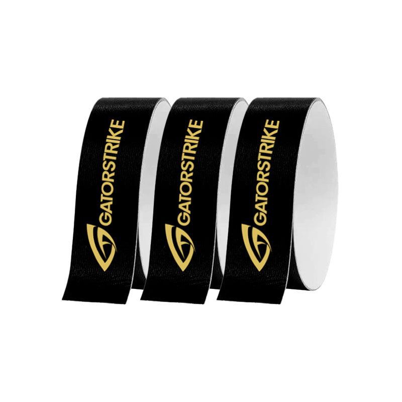 Three upright rolls of GATORSTRIKE™ Edge Guard Tape - 3 Pack are displayed on a plain white background. Each black roll features the GATORSTRIKE name and gold logo, designed to provide reliable pickleball paddle edge protection.