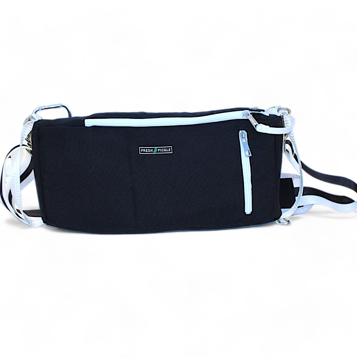 The Fresh Pickle Insulated Cooler Bag, black with white zippers and adjustable straps, features a front pocket and “RELÈN POCKET” patch. Ideal for court essentials or as a light cooler alternative, it’s shown against a white background.