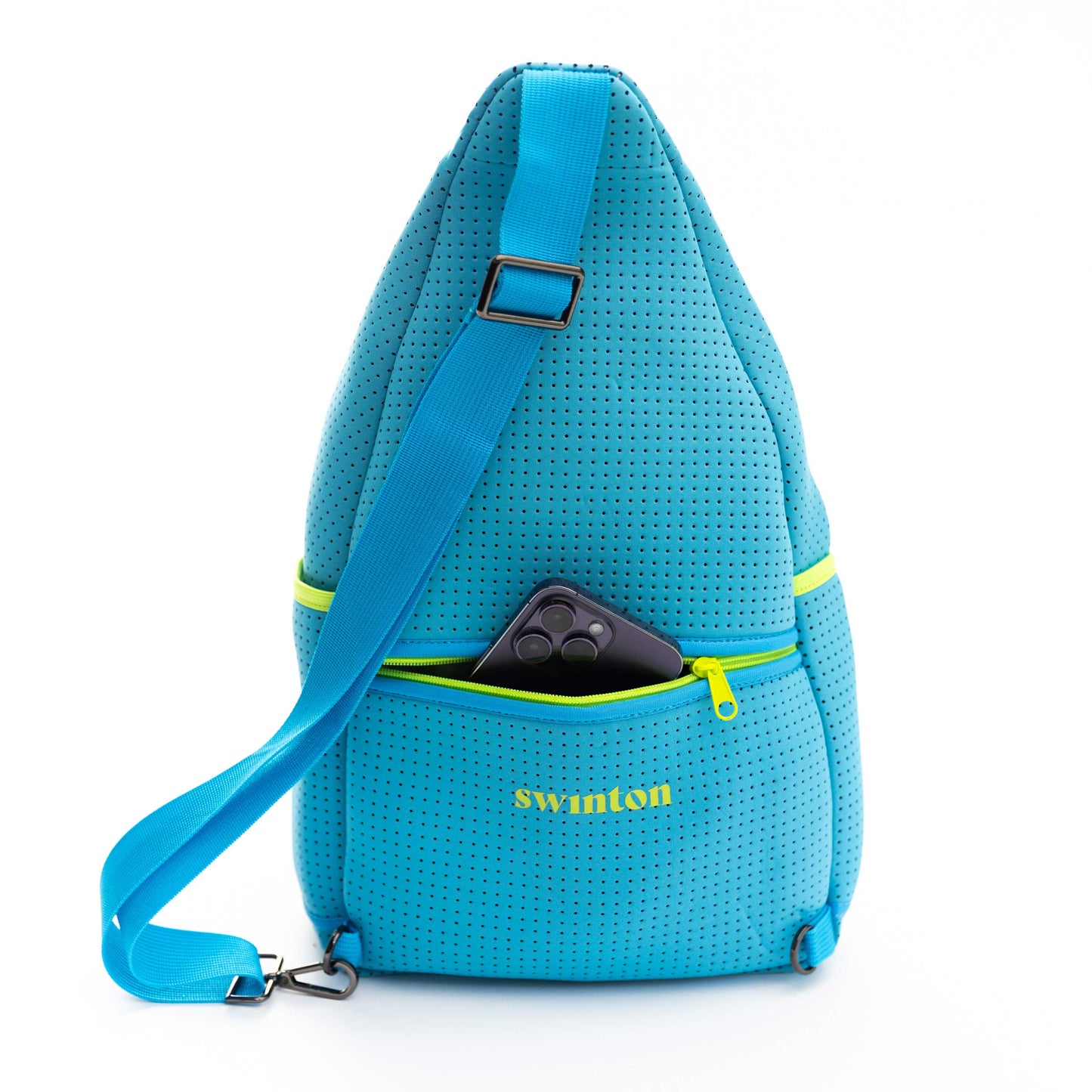 The Swinton Pickleball Sling Bag - Blue, made of perforated neoprene, stands upright with a blue strap and yellow zipper. A black phone is visible in the front zip pocket, featuring the Swinton Pickleball logo in yellow on a plain white background.