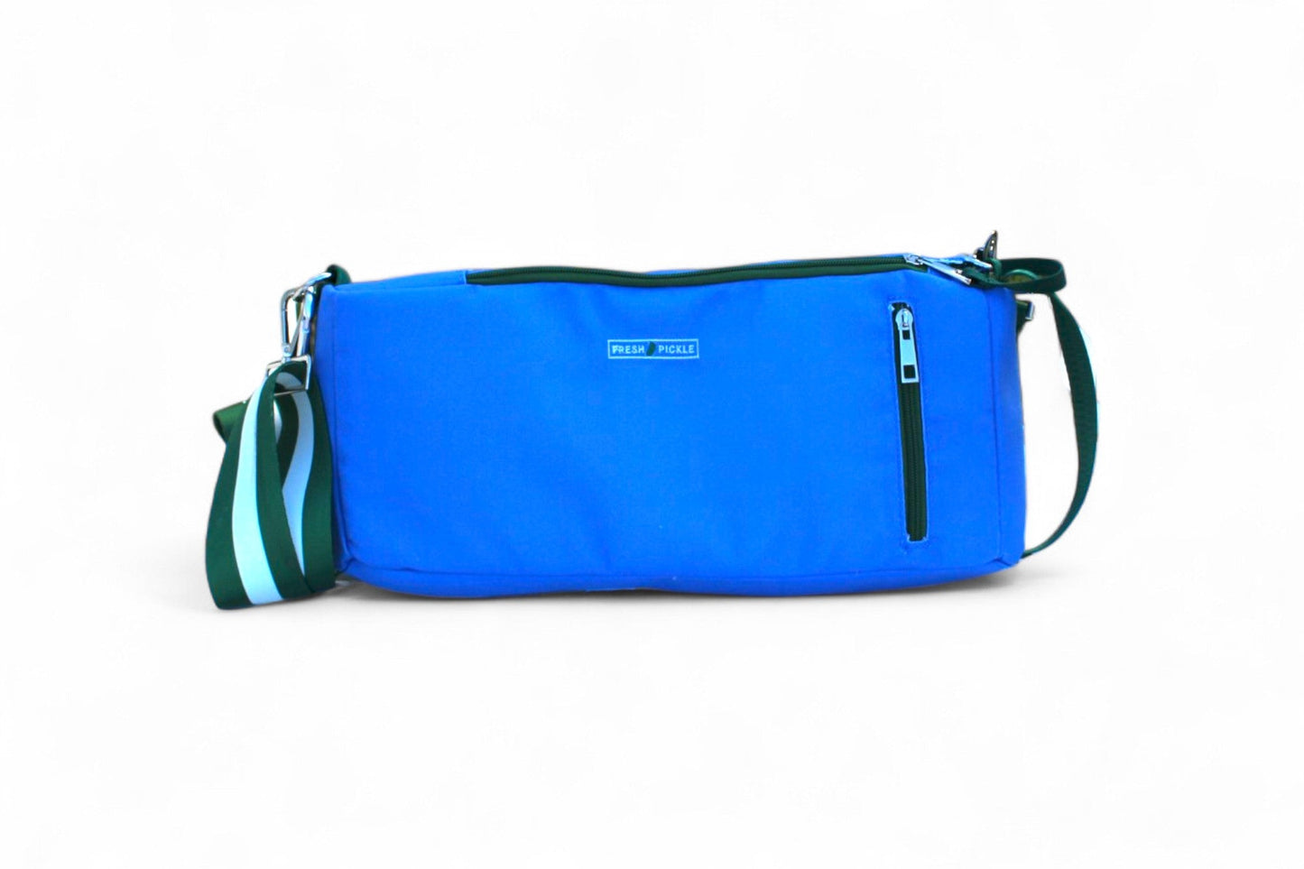 The Fresh Pickle Insulated Cooler Bag is rectangular and bright blue, featuring a green zipper, green trim, and a blue/green striped detachable strap. Perfect for court essentials or as a stylish soft-sided cooler. The background is plain white.