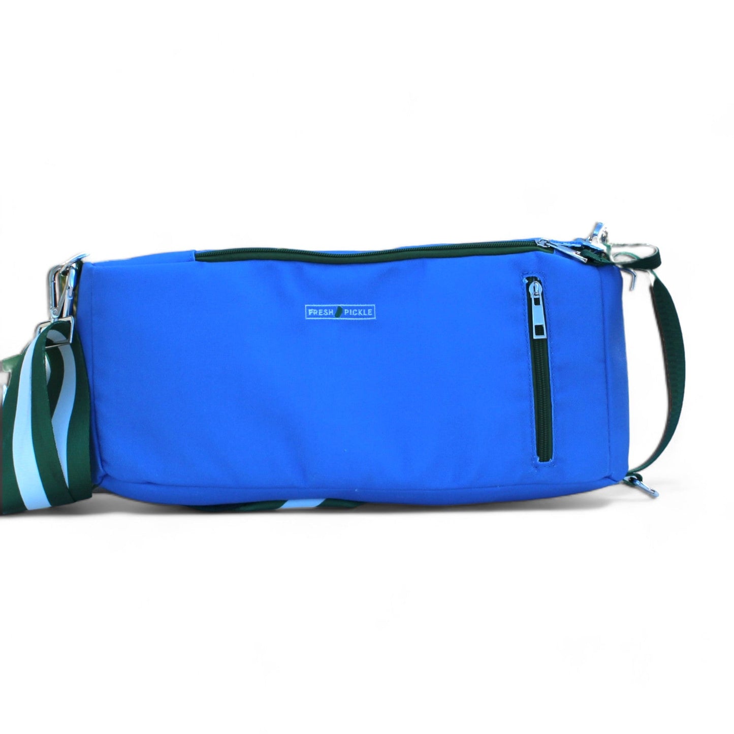 The Fresh Pickle Insulated Cooler Bag in royal blue features a small front zip pocket, silver zippers, branded patch, and an adjustable green, white, and blue striped strap—ideal for carrying court essentials in style.