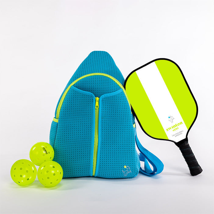 The Swinton Pickleball Starter Bundle - Blue features a blue sports bag, black-white-yellow paddle, and three yellow pickleballs, all neatly arranged against a plain white background.