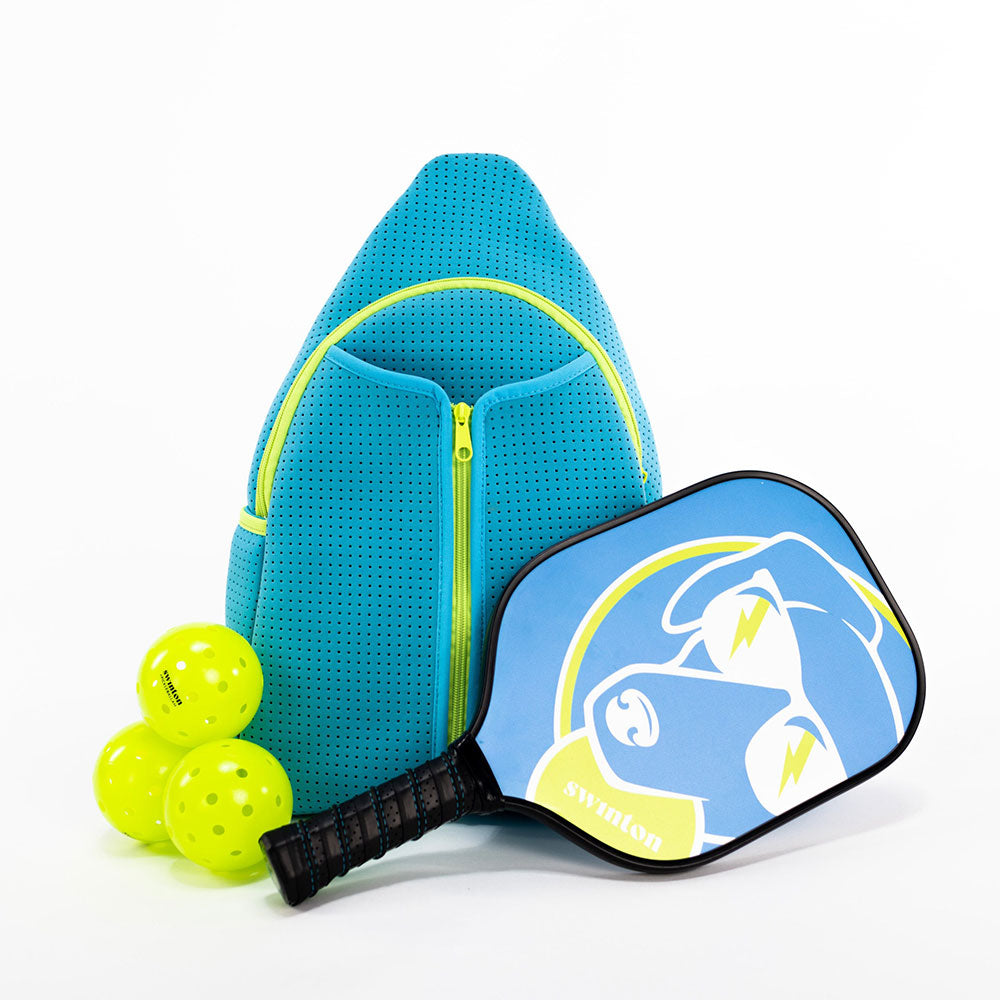 The Swinton Pickleball Starter Bundle - Blue includes a blue backpack, a blue and yellow paddle with a dog graphic and "Swinton" text, plus three yellow pickleballs—perfect as a starter set or thoughtful gift.