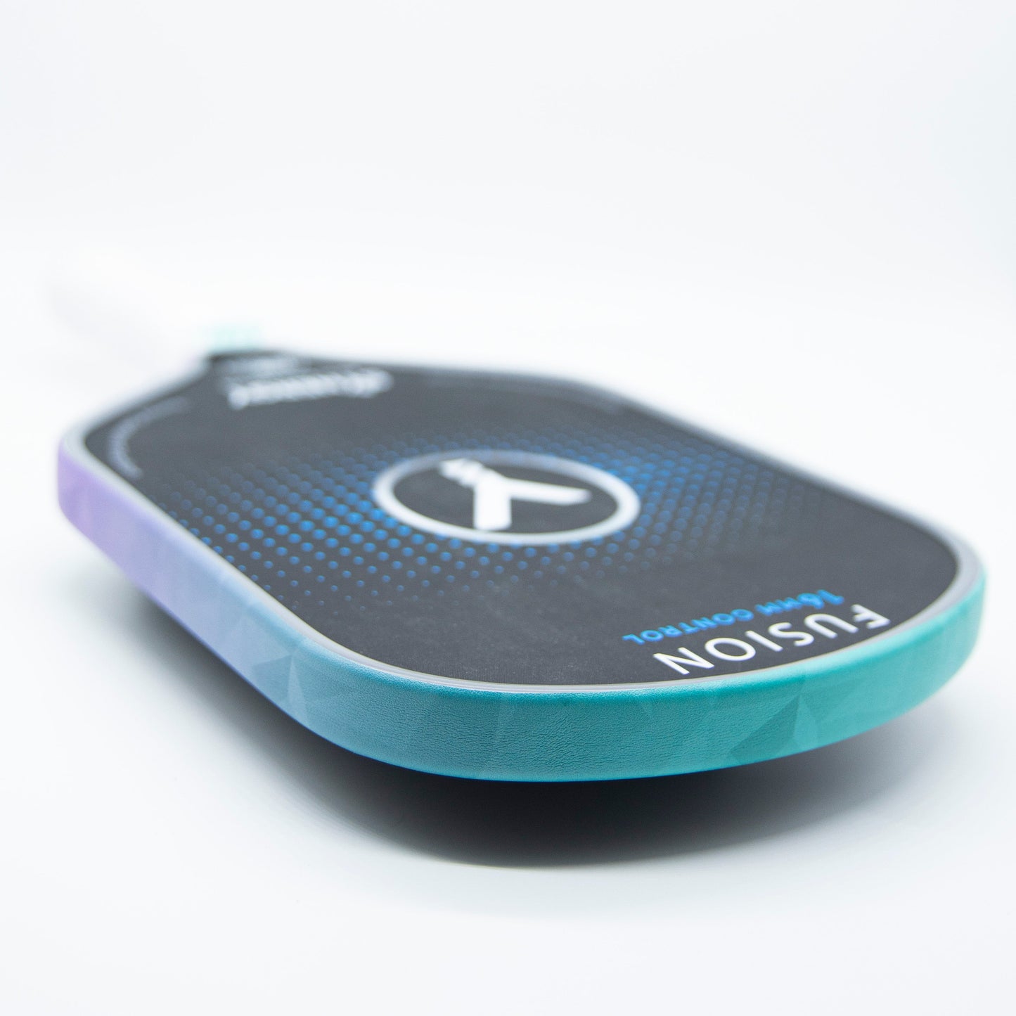 A close-up of a teal and purple Bodhi Performance paddle with "FUSION" and "Touch Control" text, plus a circular Y logo. The paddle features Bodhi Performance - Premium Edge Tape for professional edge guard protection, lying on a white surface.