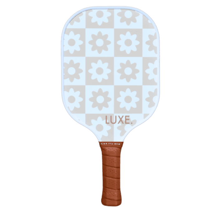 The LUXE Pickleball "Checkered Flower" paddle features a blue and white checkered face with white flowers, "LUXE" branding, and a brown grip reading "kiss my ace." USA Pickleball Approved and designed for top performance.