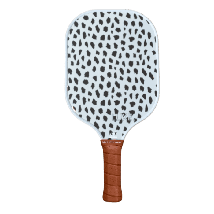 The LUXE Pickleball "Cheetah" paddle features a white face with irregular black spots like cheetah print, a brown grip band on the handle, and "kiss my ace" near the top, all set against a plain white background.