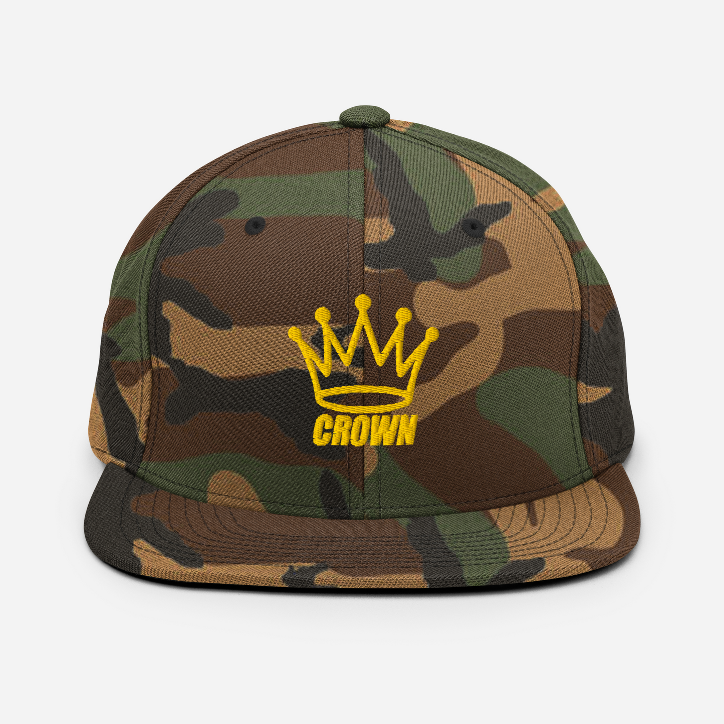 The Crown Pickleball Corona Snap-back Hat (Camo) features green, brown, and black camo with a yellow embroidered crown and “CROWN” on the front. This adjustable flat brim hat by Crown Pickleball stands out against a white background.