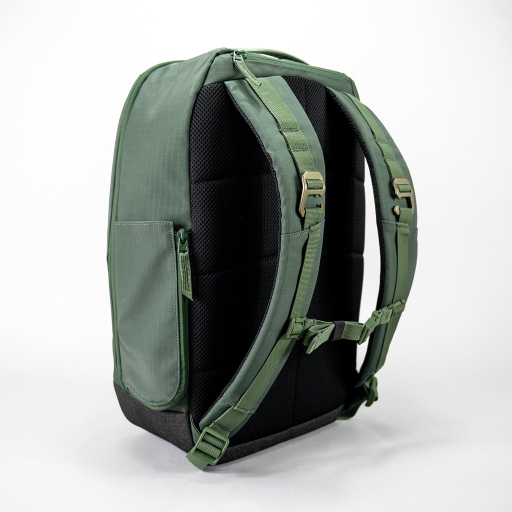 The FORWRD Court Ranger Pickleball Backpack in green is shown from the back with padded black panels, thick adjustable straps, plastic buckles, a side pocket, and a black bottom—making it a top pickleball bag under $200.