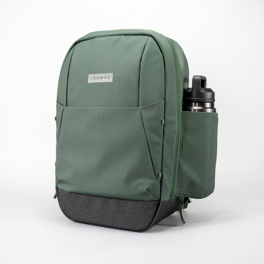 The FORWRD Court Ranger Pickleball Backpack features a green design with a black base, zipper pocket, side pockets, and a silver water bottle on the right—all set against a white background. A top pickleball bag under $200.