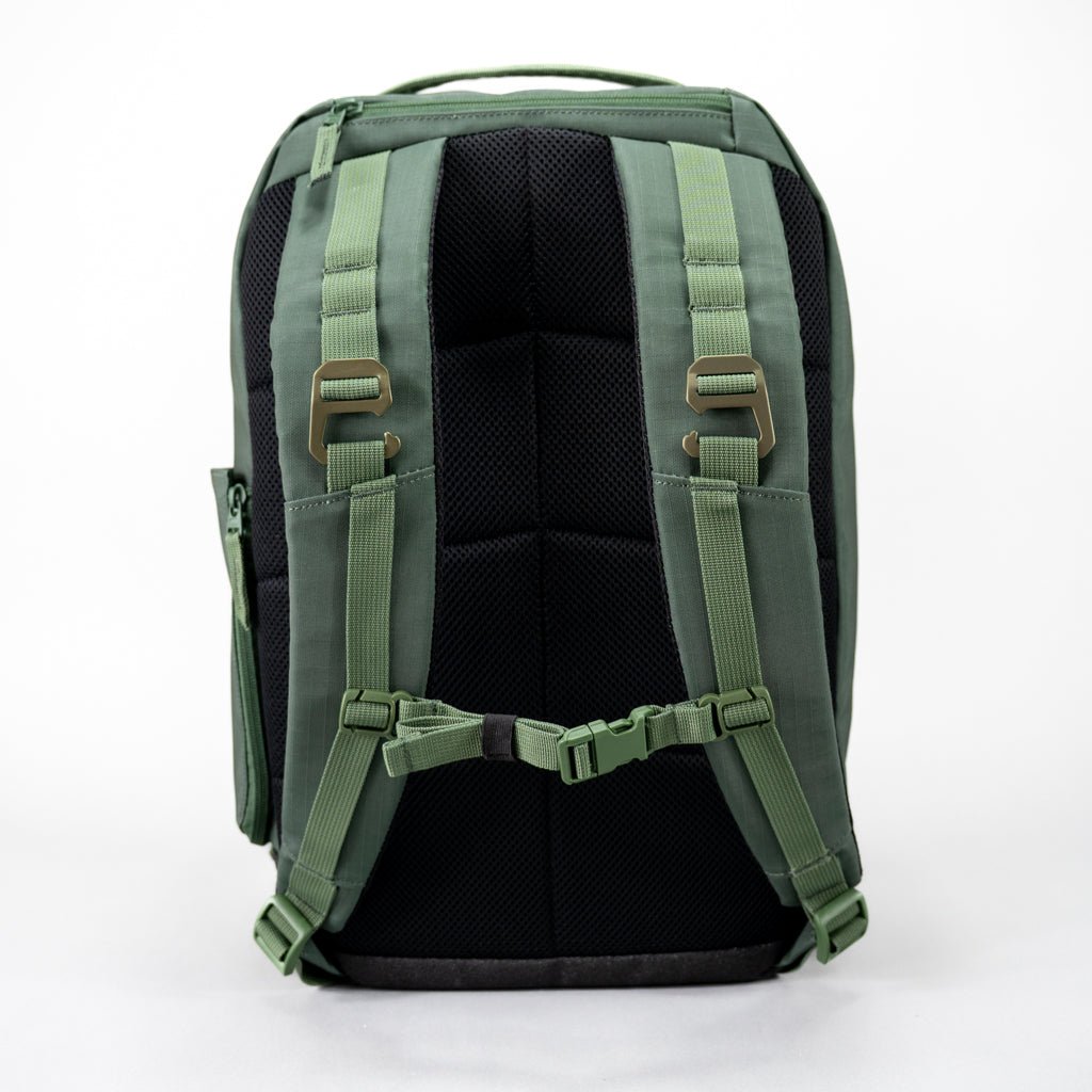 The FORWRD Court Ranger Pickleball Backpack is shown from the back in green and black, featuring padded adjustable shoulder straps, a sternum strap, cushioned black back panel, and green top handle. Top choice for pickleball bags under $200. Plain white background.