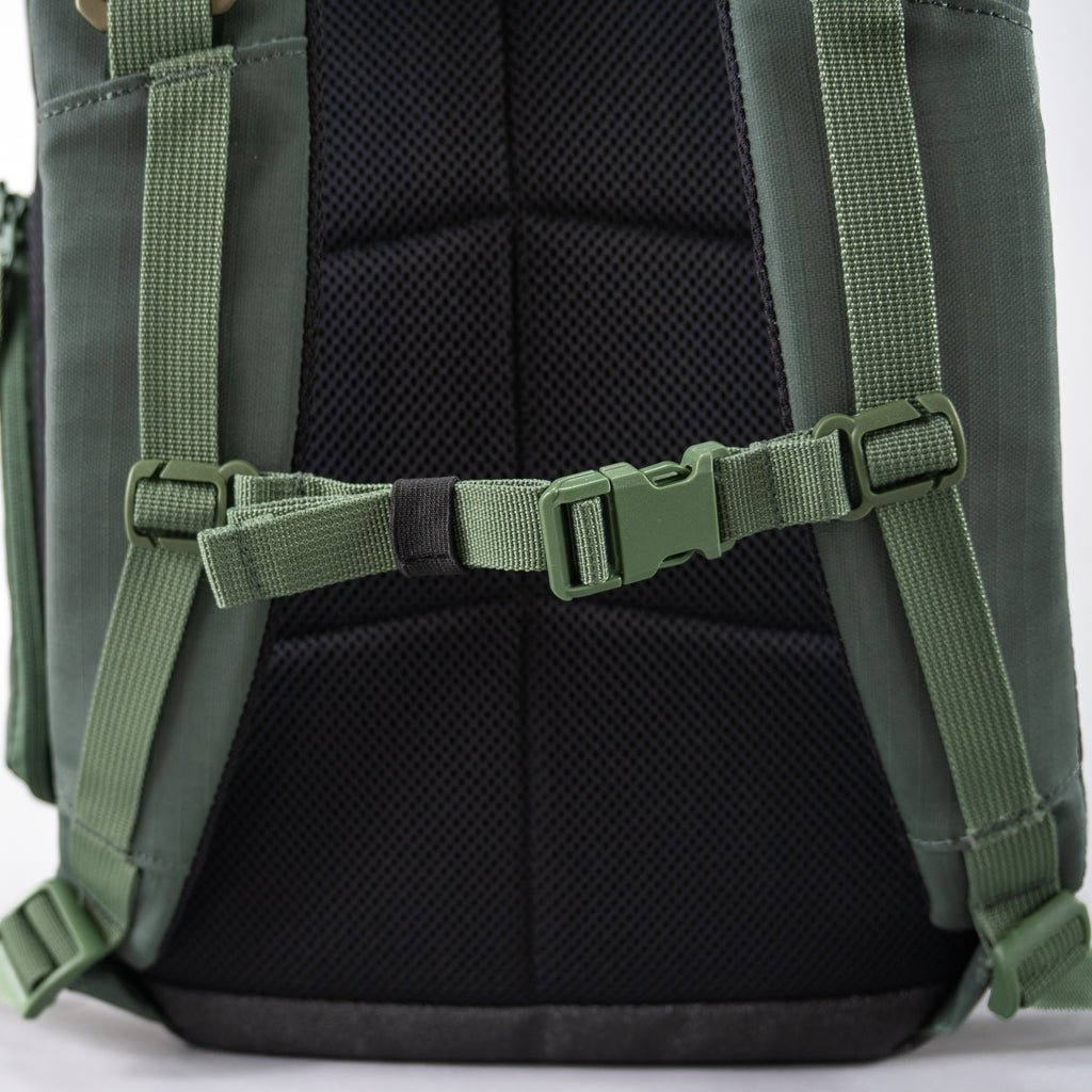 Close-up of the FORWRD Court Ranger Pickleball Backpack, with padded black mesh back and two adjustable green shoulder straps featuring a center chest strap with green buckle. Detailed stitching and texture highlight this top pickleball bag under $200.