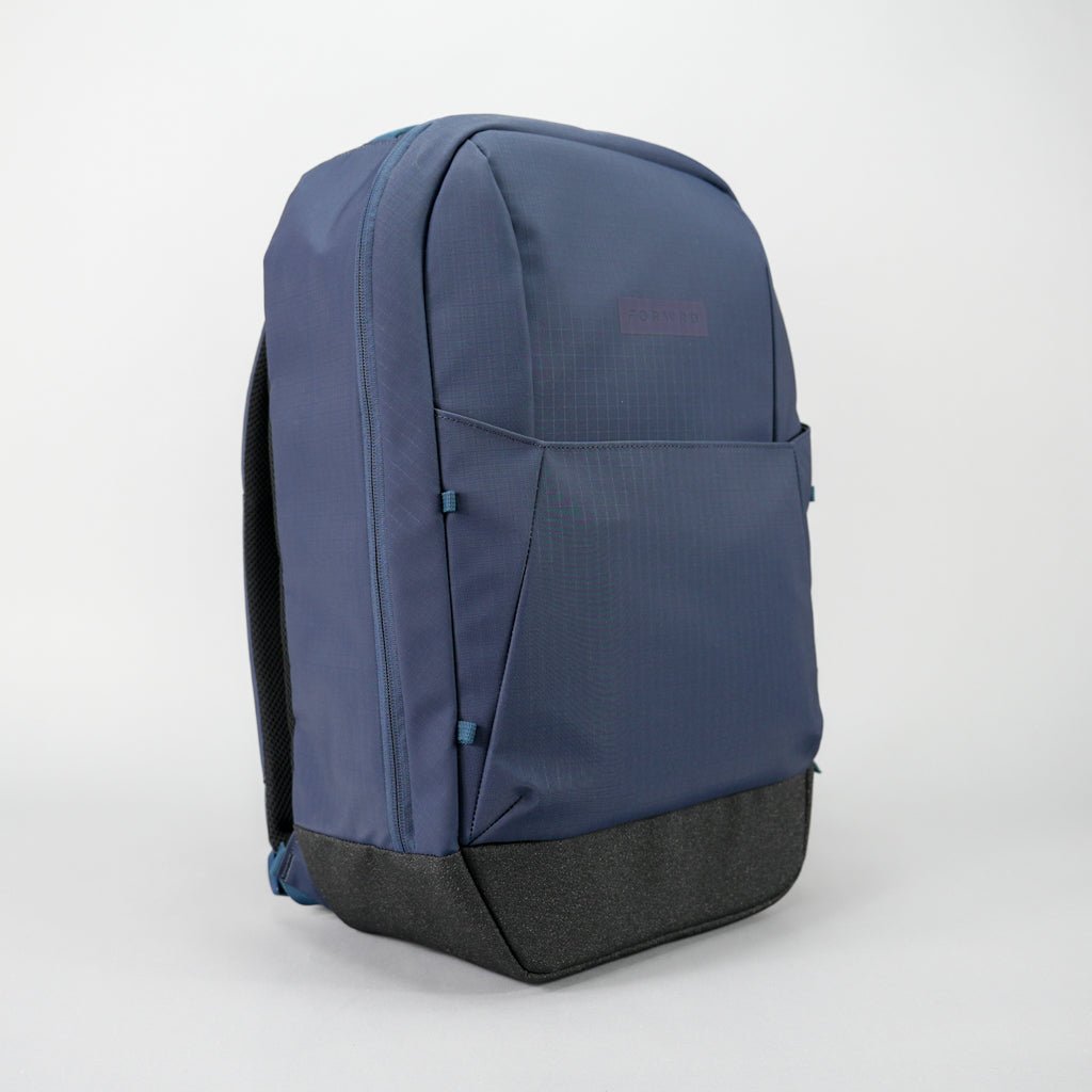 The FORWRD Court Ranger Pickleball Backpack features a navy blue, minimalist design with an outer front pocket, black textured bottom, padded shoulder straps, and a subtle logo—making it the top pickleball bag under $200.