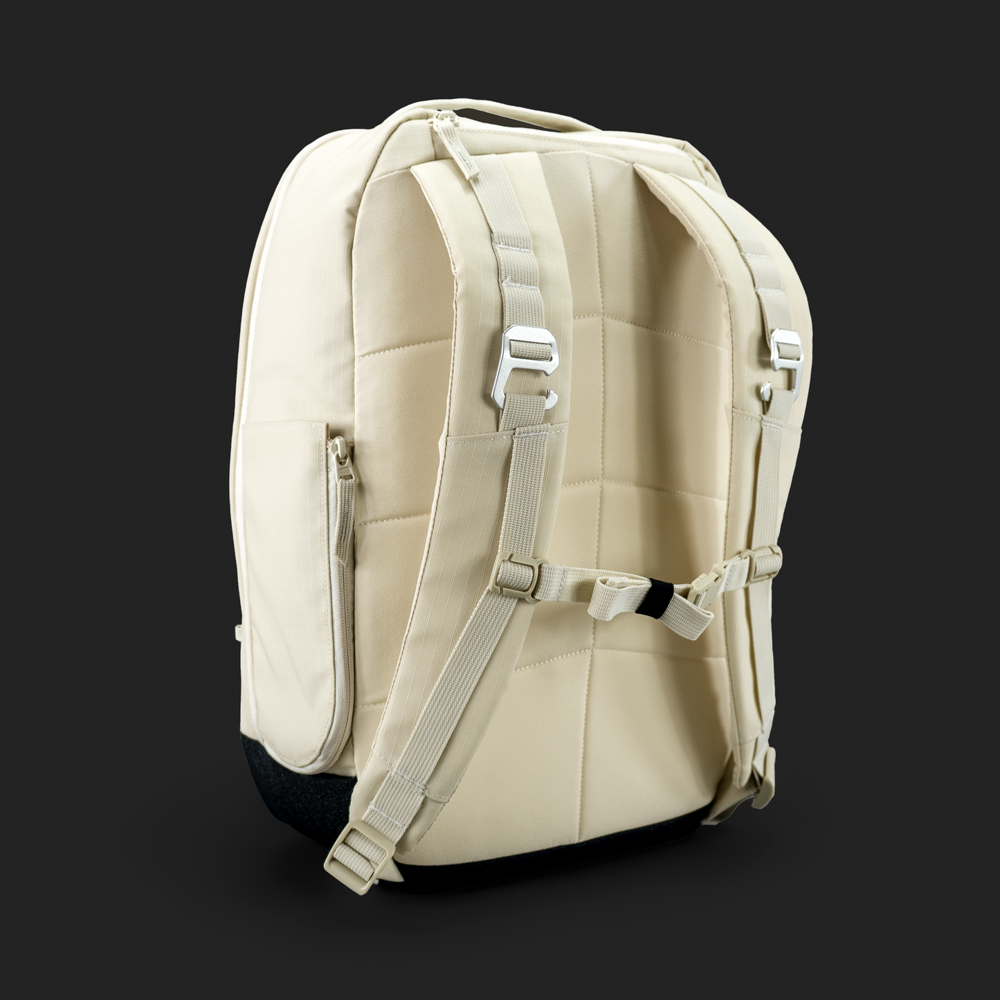 The FORWRD Court Ranger Pickleball Backpack in beige is displayed against a dark background, showcasing its padded shoulder straps, adjustable sternum strap, quilted back panel, and minimalist design with light zippers and buckles.