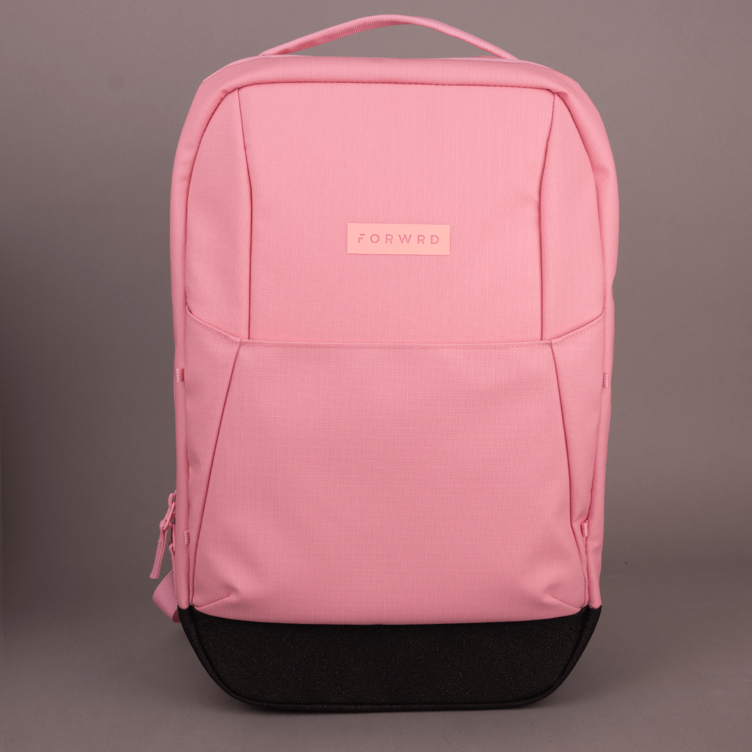 The FORWRD Court Ranger Pickleball Backpack, featuring a pink rectangular design with a black bottom, top handle, matching zipper tabs and stitching, and a small FORWRD patch on the front, is displayed against a plain gray background.