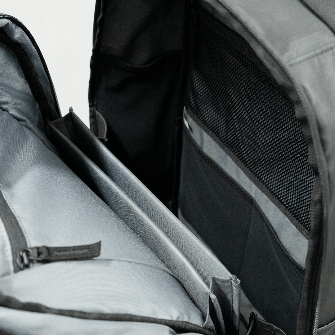 Close-up of the FORWRD Court Ranger Pickleball Backpack interior, featuring a grey and black color scheme with multiple compartments, a padded section, mesh zippered pocket, and organizational slots for easy storage.