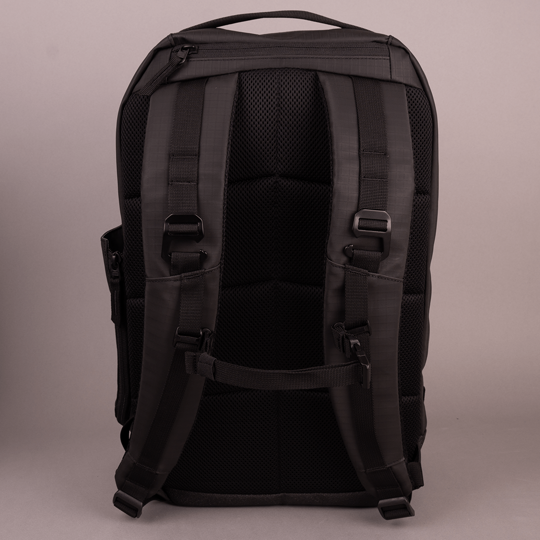 The FORWRD Court Ranger Pickleball Backpack is shown from the back, highlighting two padded shoulder straps, a top handle, and a padded back panel with buckles and adjustable straps, all set against a plain light background.