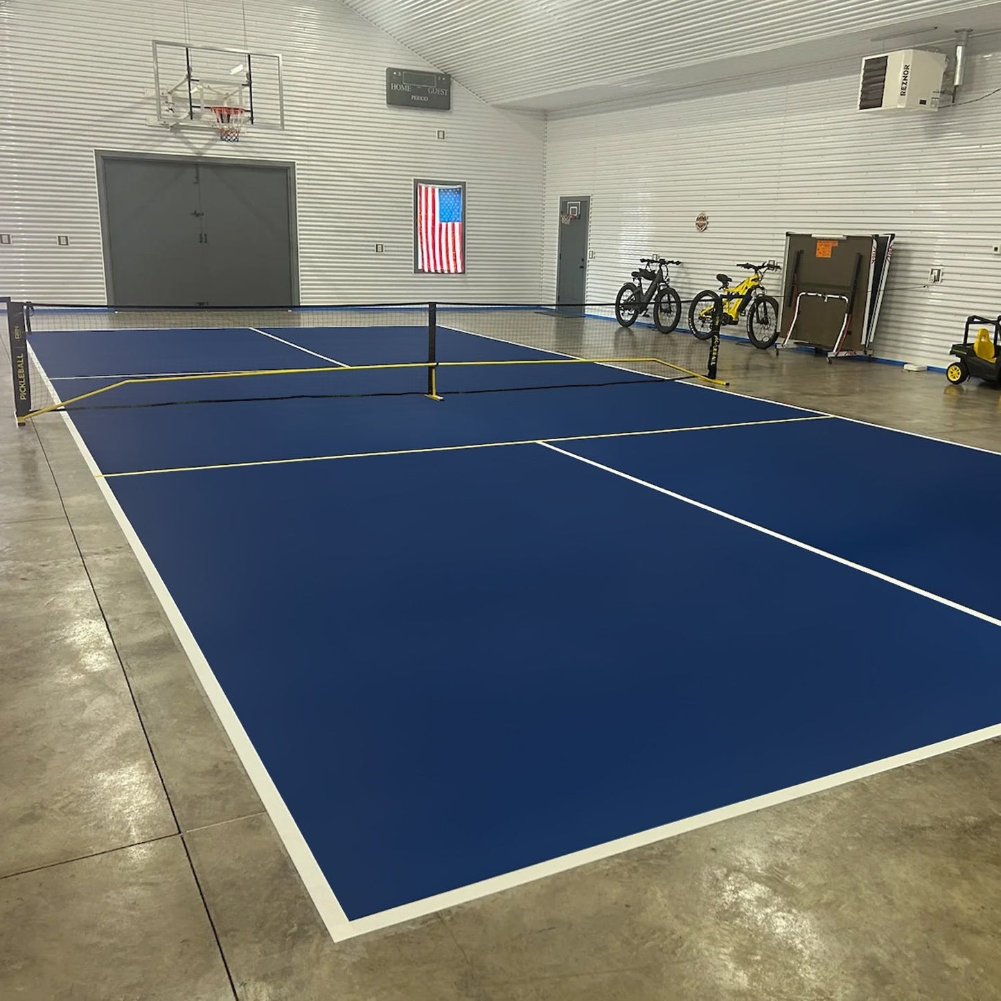 A large building’s tennis court uses Alpha Grip Non-Slip Stripe and Athletic Court Paint by SlipDoctors to enhance safety.