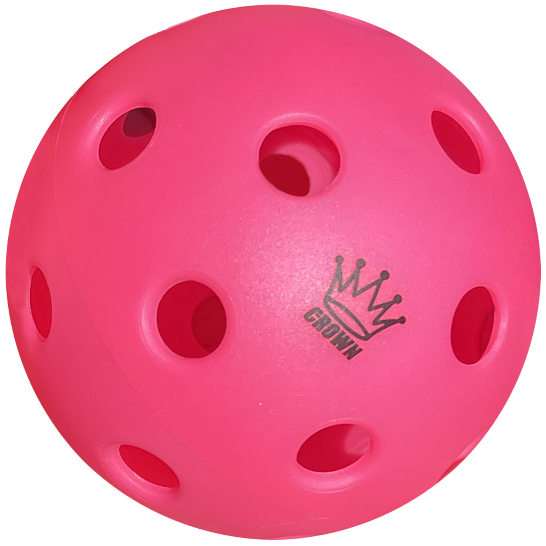 The Crown Pickleball High-Performance INDOOR Pickleballs (3-Pack Dragonfruit) feature bright pink, perforated plastic with a black crown graphic above "CROWN" on one side. Designed for control, the pickleball is shown against a plain white background.