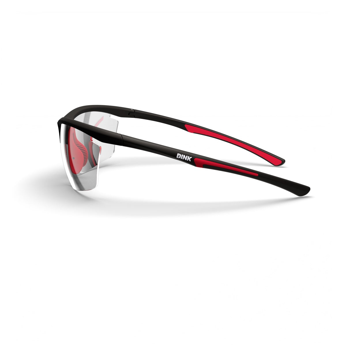 The Daytona Petite Pickleball Sunglasses by Dink Eyewear feature black, lightweight frames with red accents, a sporty semi-rimless wrap design, reflective-tint lenses, and “DINK” in white on the arm. Shown on a white background.