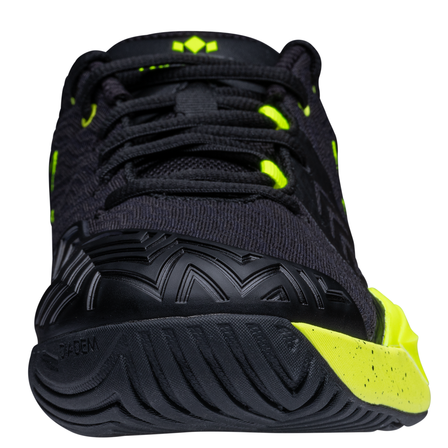A close-up front view of the Diadem Court Burst by Diadem Sports, a black tennis shoe with bright yellow accents, a textured sole, black laces, geometric toe cap patterns, and a performance knit upper with synthetic overlays for a sporty look.