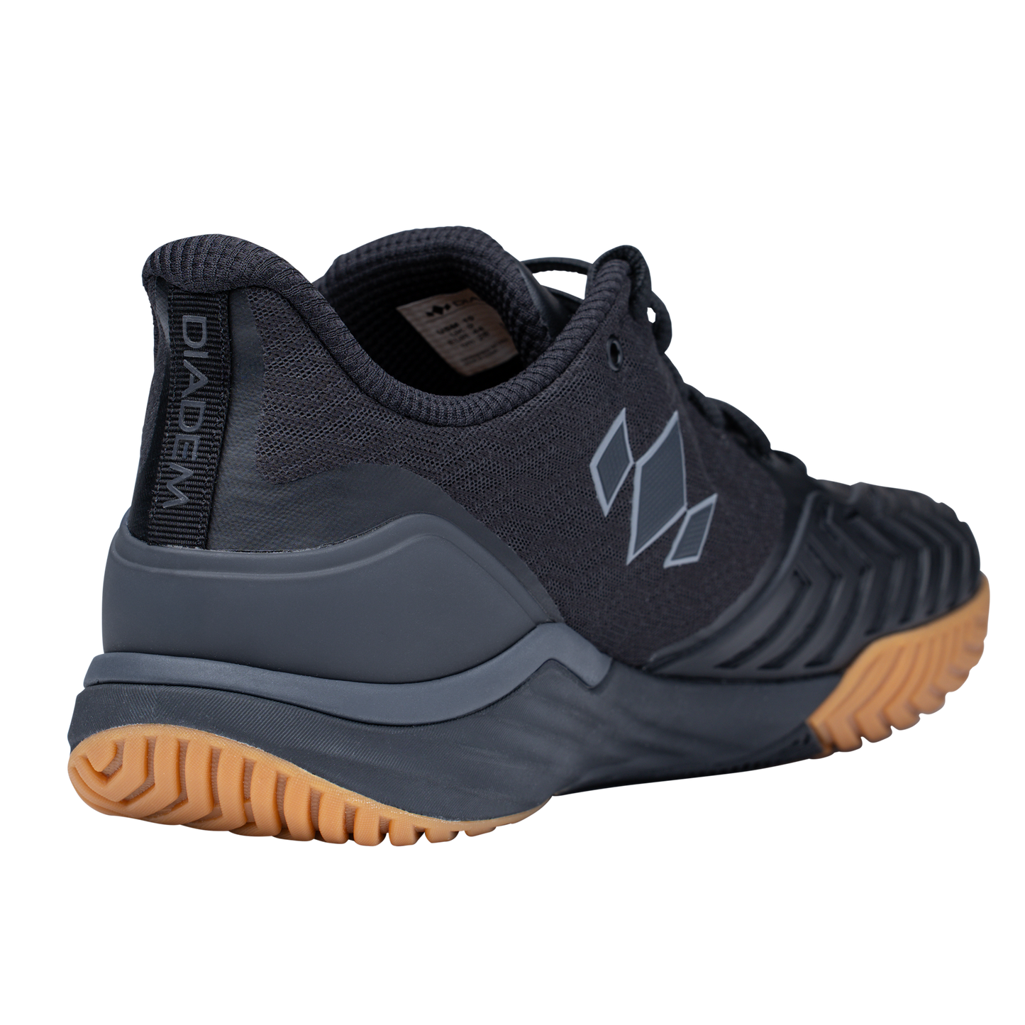 A dark gray Diadem Court Burst court shoe by Diadem Sports, shown from the back left, with a textured tan rubber sole for tennis or pickleball, mesh upper with geometric light gray designs, vertical heel tab, and molded overlays for support.