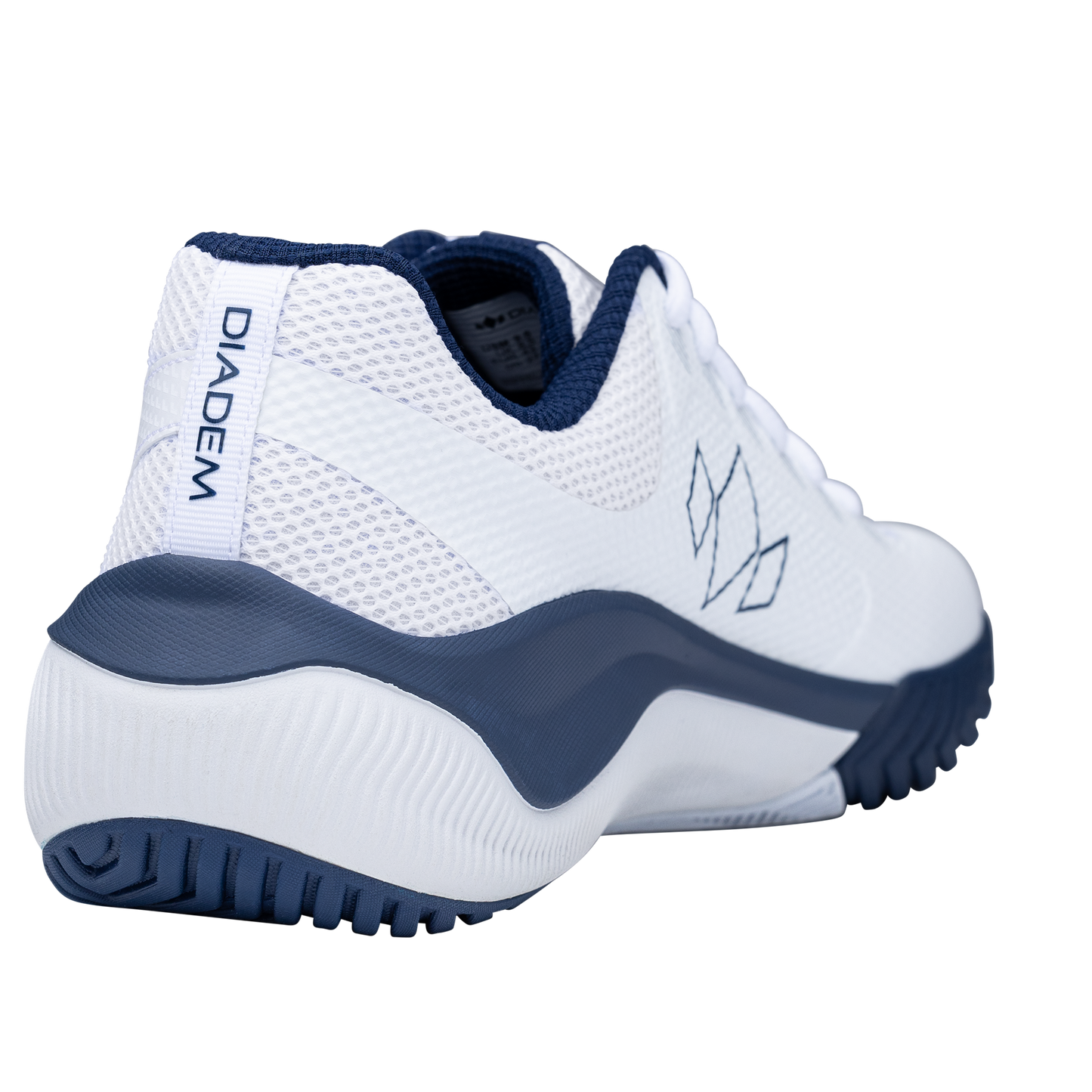 The Diadem Sports Diadem Court Flo is a white tennis shoe with navy accents, seen from the back left. It features a breathable mesh upper, navy outsole, "DIADEM" heel tab, navy lining, and a stylized logo on its textured grip sole.