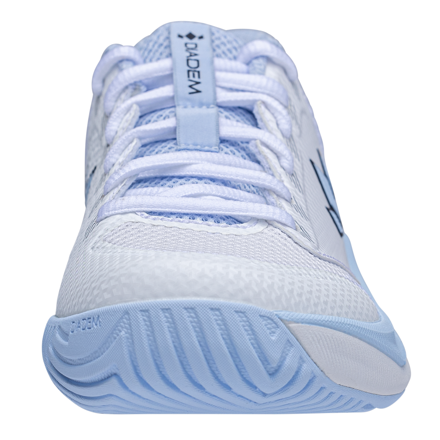 A close-up, front-facing view of the Diadem Sports Court Flo tennis shoe in white and light blue, featuring a textured rubber toe, mesh upper, blue accents, responsive cushioning, white laces, and “Diadem” branding on the tongue and side.