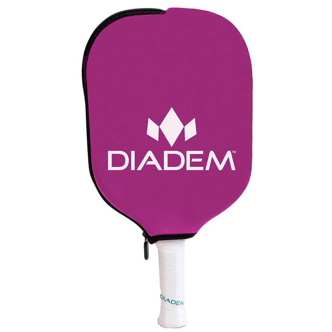 The Diadem Paddle Cover by Diadem Sports is a purple neoprene cover with the white Diadem logo and name, protecting a pickleball paddle. The handle, wrapped in white grip tape marked "DIADEM," is visible below the zippered cover against a white background.