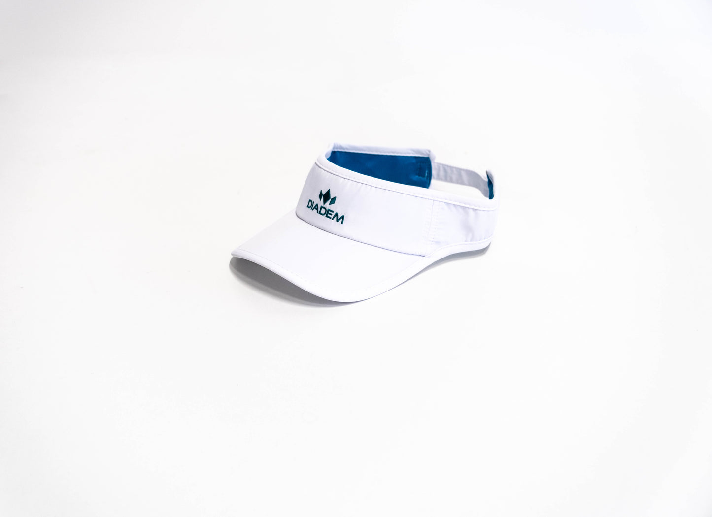 The Diadem Sports Performance Snapback Trucker Sun Straw Visor Hat features a white curved brim, blue inner lining, and the word BADEM beneath a green leaf logo on the front, displayed on a plain white background.