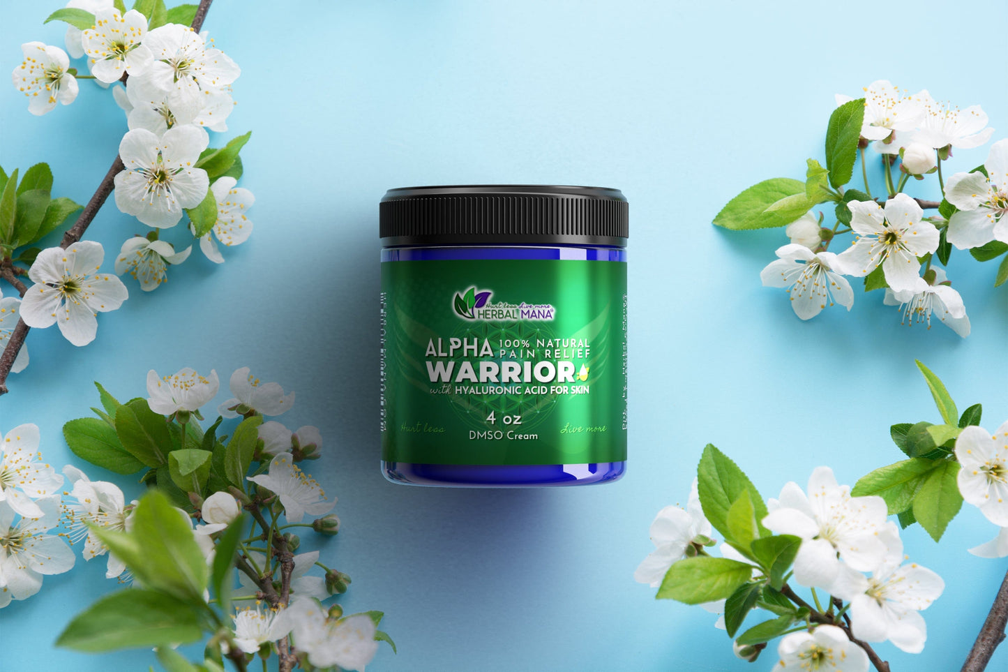 A blue jar of “DMSO Cream for Joint & Muscle Recovery | Alpha Warrior” by Herbal Mana rests on a light blue surface with white blossoms and green leaves, highlighting natural relief for joint pain with hyaluronic acid.