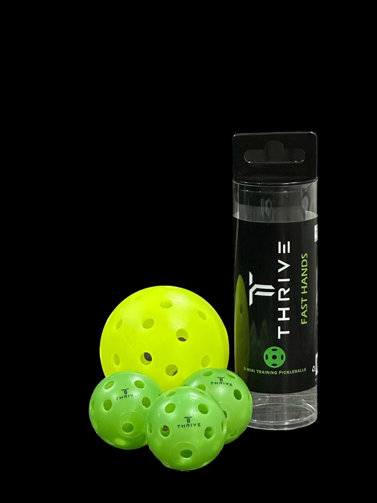 A clear plastic tube labeled Fast Hands by Thrive Pickleball holds neon green balls for training. Three small green balls with THRIVE logos and a larger yellow ball are in front, all set against a solid black background.