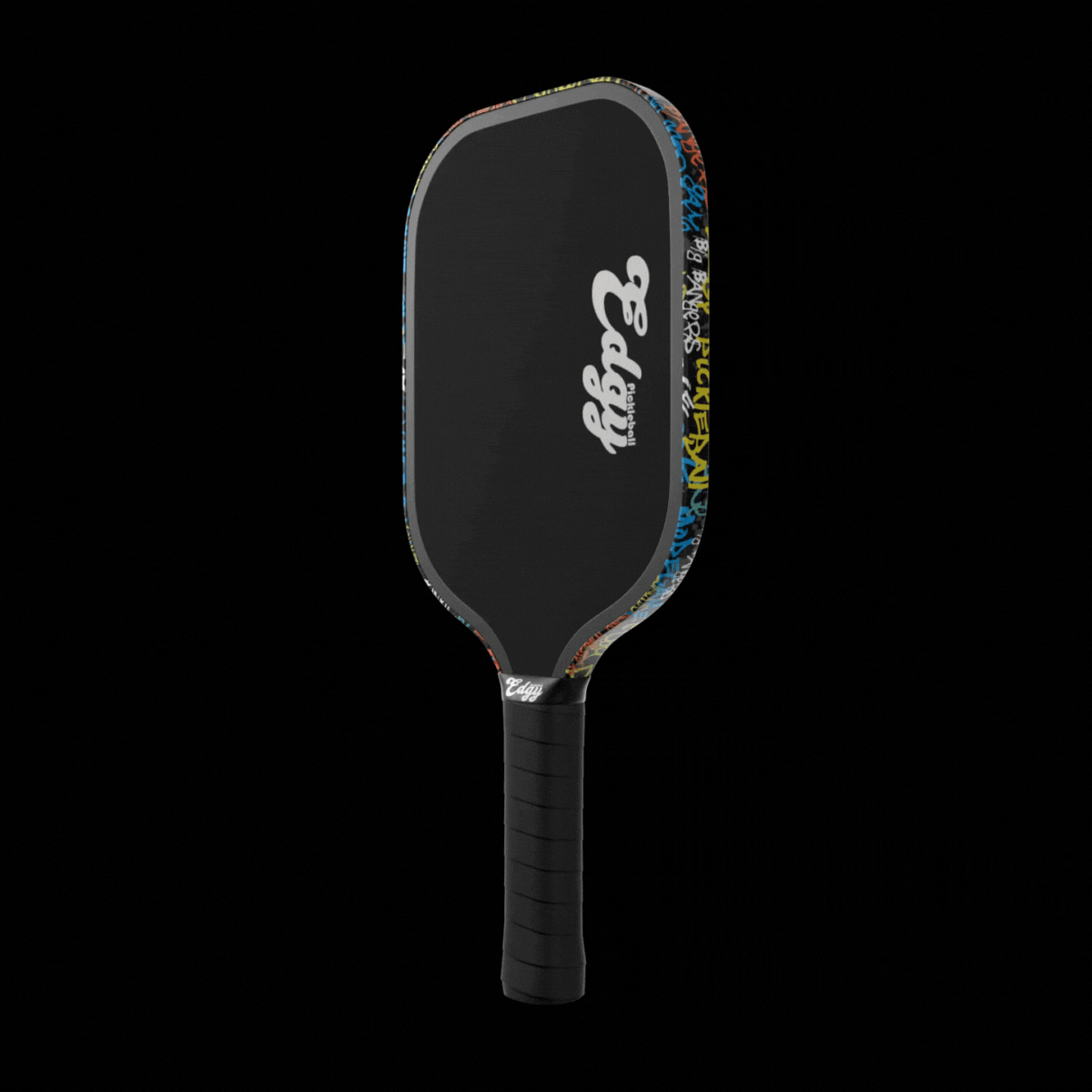 A black pickleball paddle with a textured grip and white Edgy Pickleball logo features Graffiti Edge Tape (3 pack) from Edgy Pickleball, adding a colorful graffiti design that contrasts with the paddle’s plain black face on a solid black background.