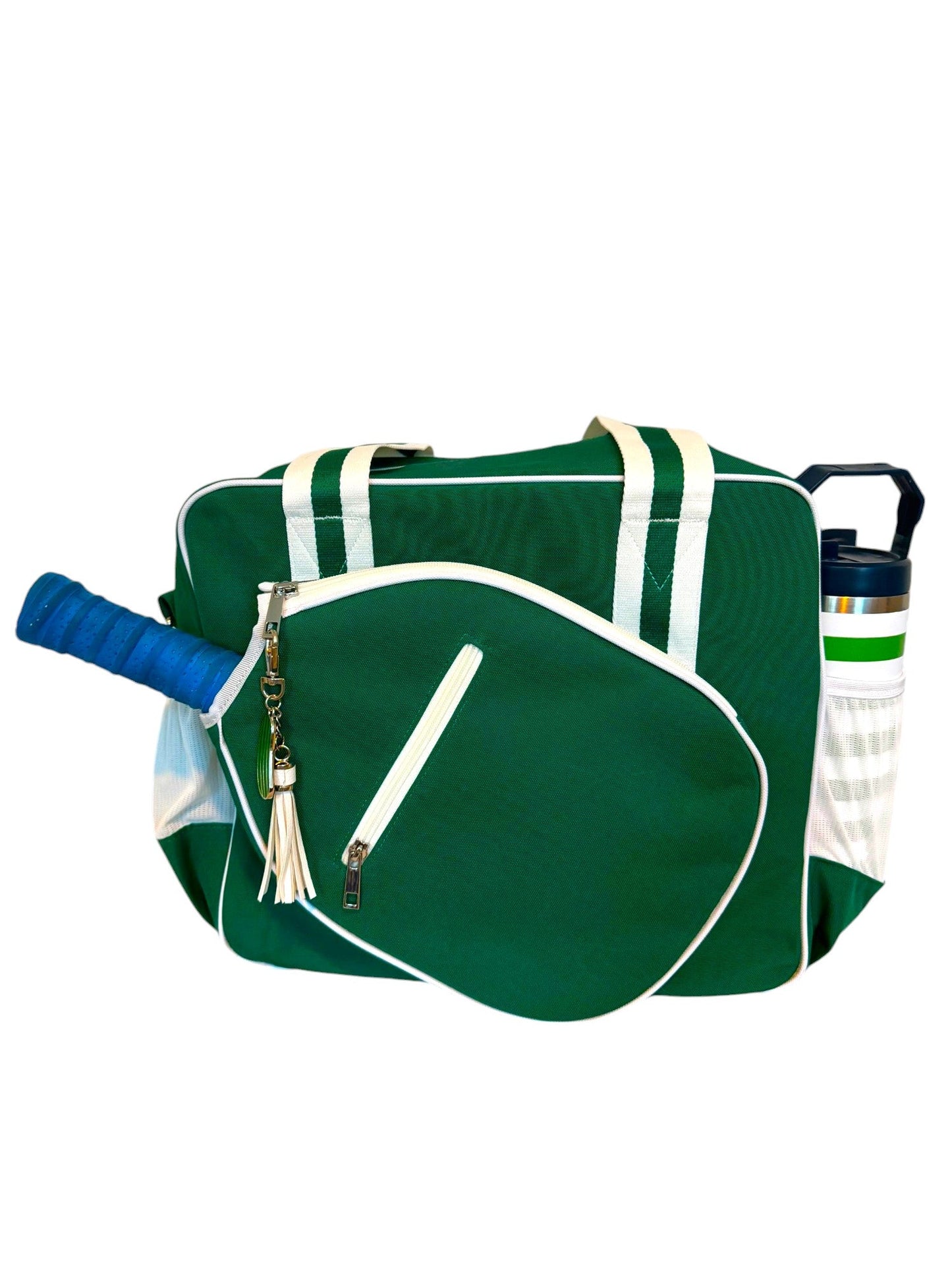 The Fresh Pickle Lola Pickleball Tote Bag features green fabric, white straps and piping, a front zip tennis racket face pocket holding a racket with a blue grip, and pickleball accessories in the white side mesh pocket.