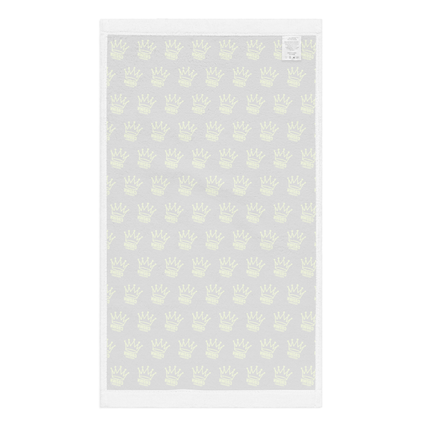 The CROWN PICKLEBALL - Corona Pattern Hand Towel (BLACK) by Crown Pickleball features a repeating crown motif on a black cotton surface, with a white border and a sewn label at the top right corner, set against a plain white background.