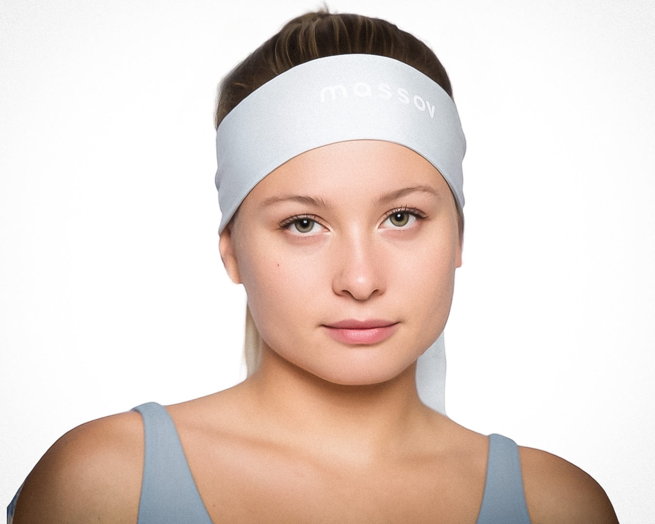 A young woman with light skin and straight, light brown hair pulled back wears a pale blue Massov Headband Tie and matching tank top, looking directly at the camera with a neutral expression against a white background.