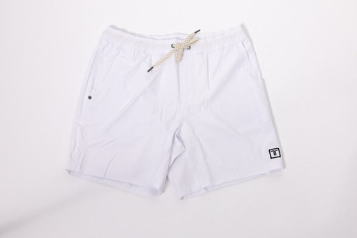 The Thrive Elite Shorts (7 in.) by Thrive Pickleball are white, lightweight stretch shorts with an elastic waistband, beige rope drawstring, two front pockets, and a small black square logo with a white T on the left leg.