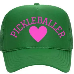 The Pickleballer Trucker Hat by Runway Athletics is a green cap with “PICKLEBALLER” in bold pink letters and a large pink heart on the front, plus a mesh back and classic curved brim.